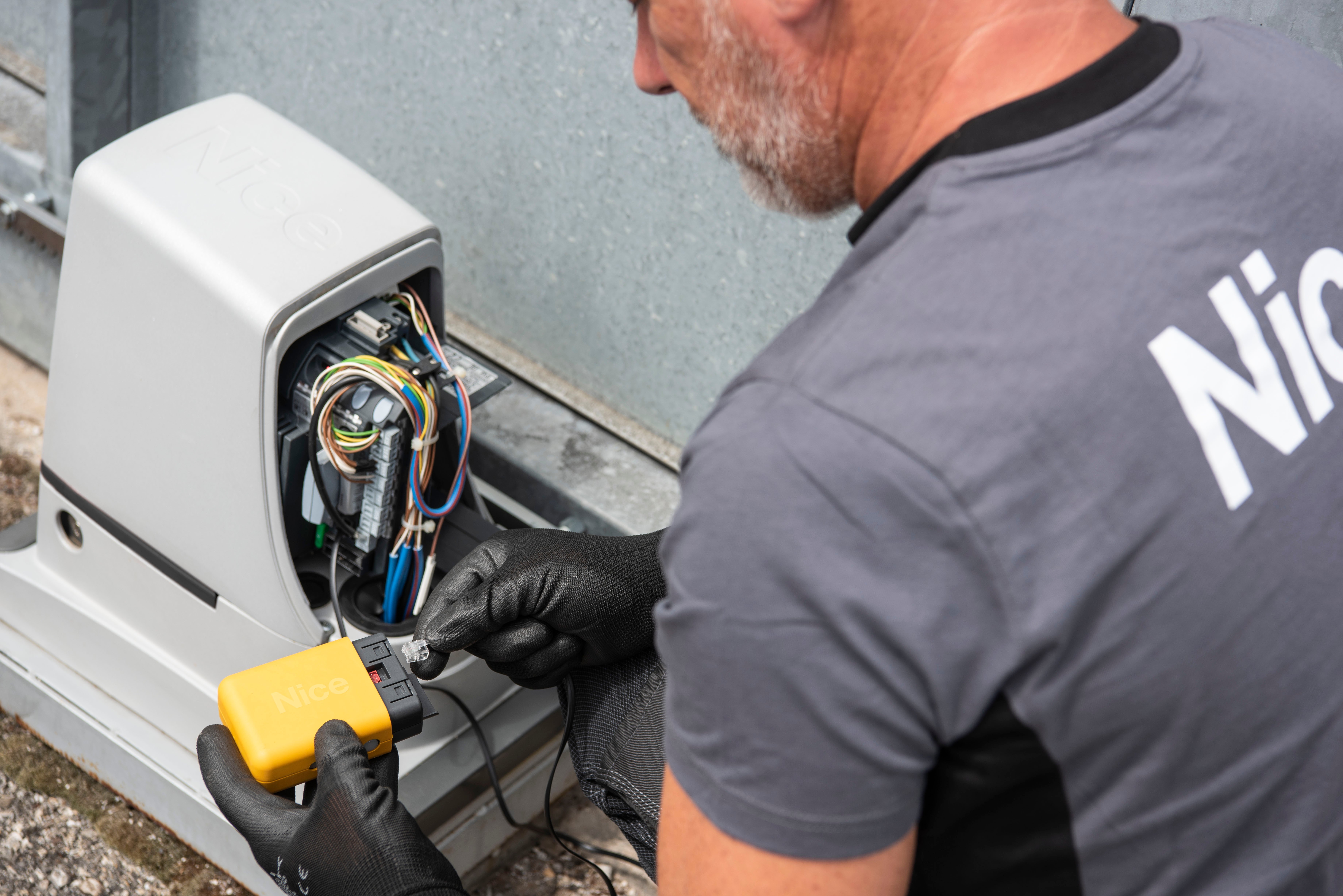 Technician installing gate automation